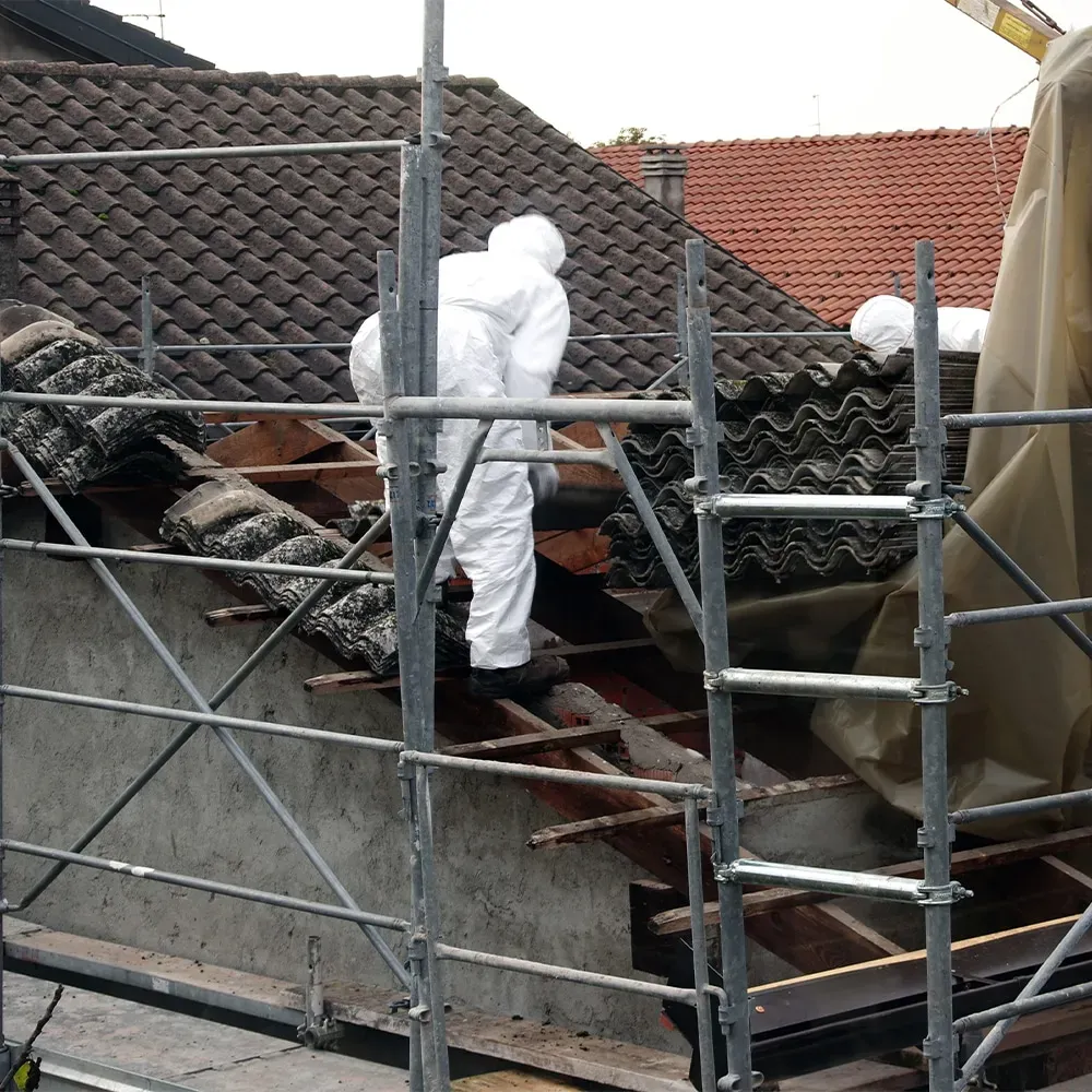 Stay Safe Environmental team performing safe asbestos roof removal on a residential property.